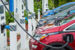 Electric vehicles charging at a row of EVgo charging stations.