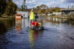 Mike Ryerson of Harlem Heights makes his way back to his home on a flooded street after Hurricane Ian surge waters flooded the area.