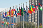 Stock image of flags of different nations in front of the United Nations headquarters in NYC