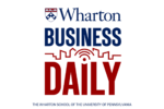 Logo for "Wharton Business Daily" with the Wharton School''s emblem, large text in blue and red, and a city skyline graphic.