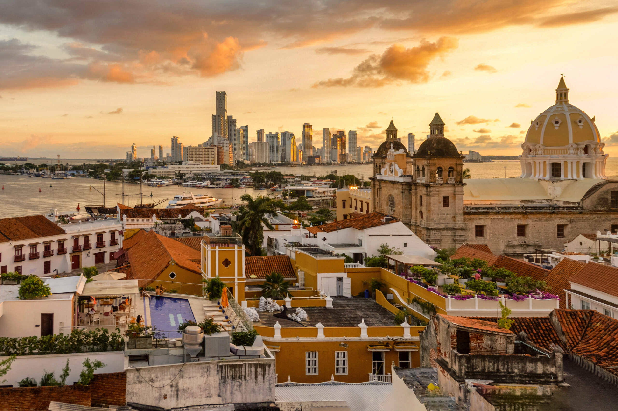 Decorative image of Cartagena Colombia Skyline At Sunset with old buildings and new buildings separated by a waterway