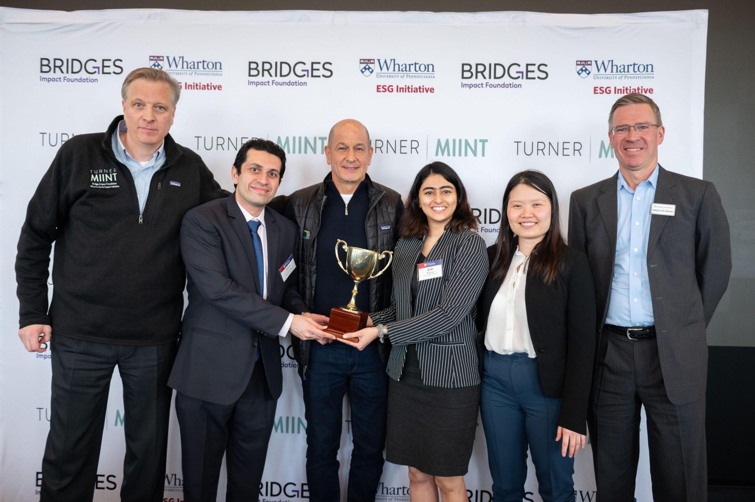 The London Business School team posed with the TMIINT trophy, Brian Trelstad, Bobby Turner, and Witold Henisz.