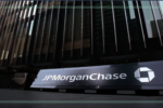 A sign reading JPMorganChase in front of a tall glass building